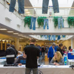 Student Activities personnel register potential bidders as shoppers browse tables stacked with goodness.