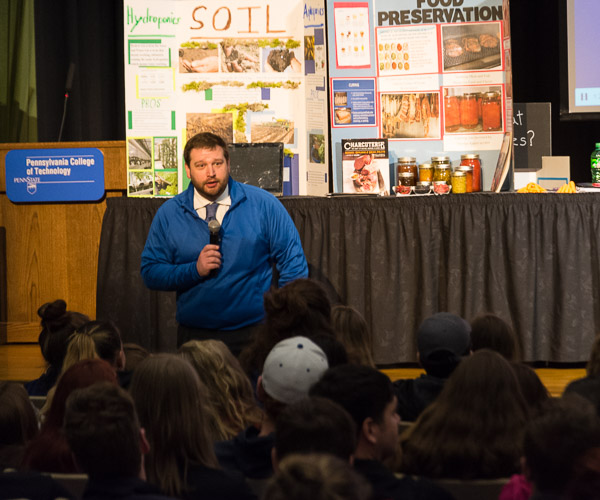 Brian D. Walton, assistant dean of business and hospitality, addresses high school students in the ACC Auditorium.