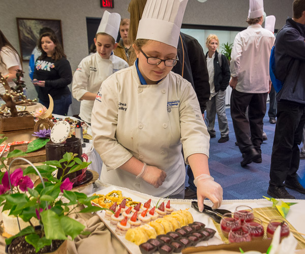 As crowds gather, Kelley arranges utensils near her section of the buffet.