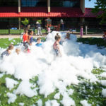 A wide shot of the courtyard shows the breadth of the soapy fun.
