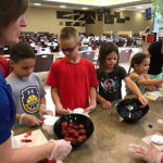 Bloom talks campers through their edible creations.