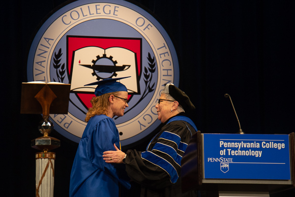 After turning the student speaker’s tassel, the president offers personal congratulations for a job – a degree and a speech – well done.