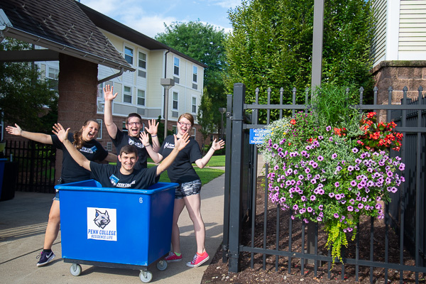 Campus View RAs are eager to welcome residents to their halls. Standing (from left): Olivia J. Hawbecker, of Chambersburg, web and interactive media; Trevor J. Route, of Canton, plastics and polymer engineering technology; Cas D. Henderson, of Hazel Hurst, business administration: banking and finance concentration. In the bin is Andy P. Luzeckyj, of Southampton, automotive technology
