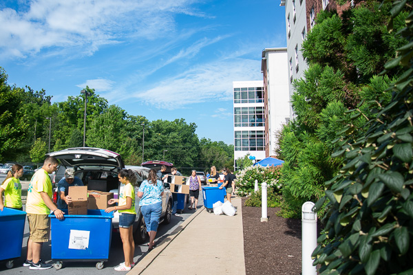 Gorgeous skies greeted families for most of the day (except for a short downpour in the afternoon). Here, movers get busy outside Dauphin Hall.