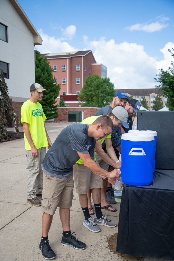 Blue skies and blue coolers are a welcome sight for these volunteers on this high-humidity day.