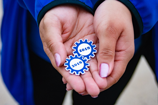 ... distributing commemorative pins that were given to participating volunteers, faculty and staff.