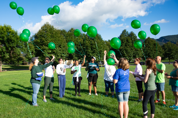 Friends and family gather in memory of a loved one lost to suicide.