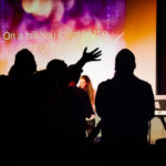 Cru's Natali J. Fargus. of Lock Haven, and Ethan M. Yoder, of Denver, lead more than 100 people in worship.