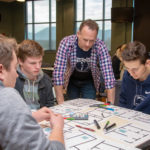 Spyke M. Krepshaw, instructor of web and interactive media, confers with students from South Williamsport.