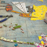 The layout of glass pieces begins.