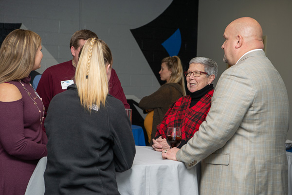 Penn College President Davie Jane Gilmour and Director of Athletics John D. Vandevere (at right) converse with attendees.