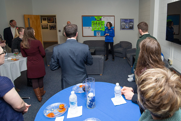 Kimberly R. Cassel, director of alumni relations, welcomes guests to the reception in the Athletics lounge.