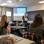 Winder (left) and Wolfhope-Briggs talk with students in a Klump Academic Center classroom.