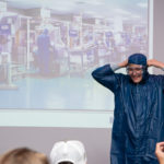 Encouraged by West Pharmaceutical Services training supervisor Tiffany Loner-Diemer, Jersey Shore student Evan Fink dons the garb required to work in West’s clean manufacturing environment.