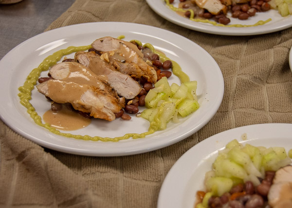 The blue team’s entrée: grilled chicken with Asian-influenced pinto beans, a peanut sauce, cucumbers and pea and horseradish drizzle