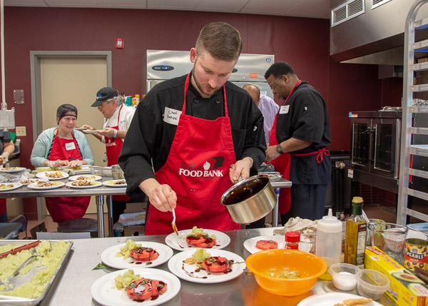 The James Restaurant’s Peter Daugherty, heading up the red team, adds a glaze to his team’s dessert …