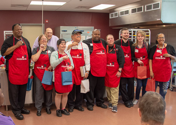 The blue team (on left) shows off its medals as the day’s volunteer contestants gather.