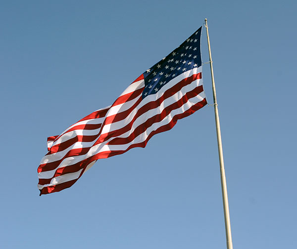 Under ideal conditions repeatedly attributed to DiSalvo's guiding spirit, the college's landmark flag flutters in a gentle evening wind.