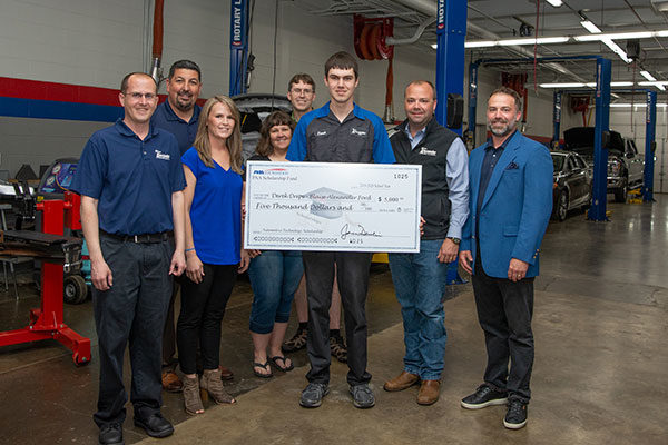 Scholarship recipient Derek T. Dreps (holding check) is surrounded by well-wishers in the Parkes Automotive Technology Center. From left are Chad Koch, general sales manager at Blaise Alexander Ford of Mansfield; Ralph Diodata, chief financial officer, Blaise Alexander Family Dealerships; Deni Cecco, regional manager for the Pennsylvania Automotive Association; Dreps’ parents, Kendra and Michael; and Aubrey and Adam Alexander.