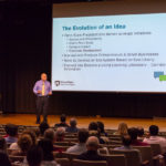 Snider takes the stage during an open session for campus employees.