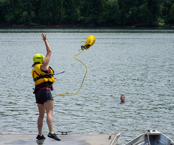 Carly R. Stahl, a paramedic technician student from Lewisburg, tosses a rescue line to Bambi A. Hawkins, learning laboratory coordinator for the paramedic program.