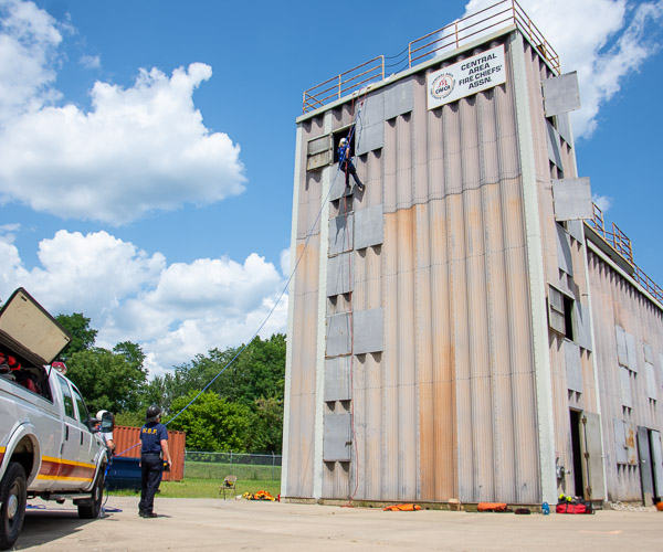 Anchored by staff from the Williamsport Bureau of Fire, Stahl descends from the fourth floor of the training mock-up.