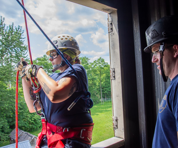 Davis secures herself before rappelling from the fourth floor.