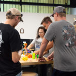 Roberta Schwenk, makerspace assistant, shows first-year students the versatile capabilities of a 3D printer.