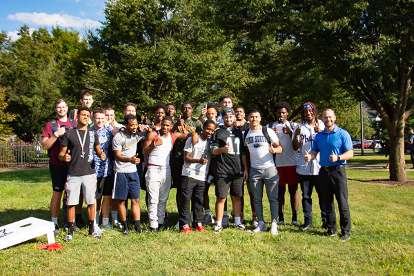 The Wildcat men's basketball team lends a welcoming presence.
