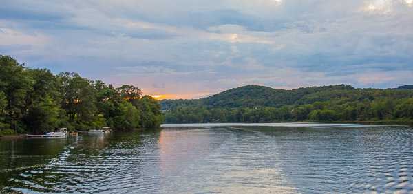 The Hiawatha travels eastward on the river, leaving a beautiful sunset in its wake.