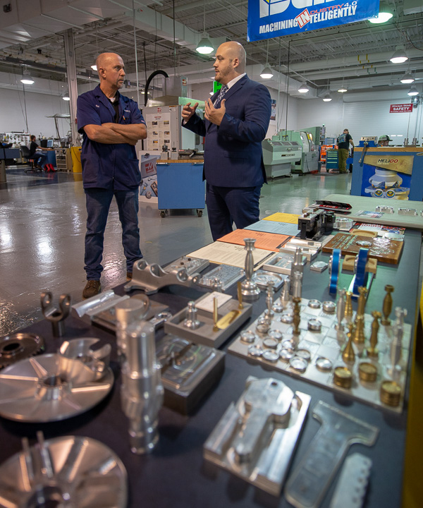 Matt Shuey (right) speaks with Richard K. Hendricks Jr., instructor of automated manufacturing and machining, in the lab.