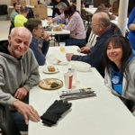 Wearing her "Penn College Pride," Brigette M. Cleary, secretary to the dean of business and hospitality, talks with a diner.