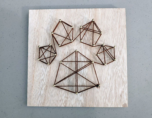 Strands of string, artfully employed, produce a familiar calling card.