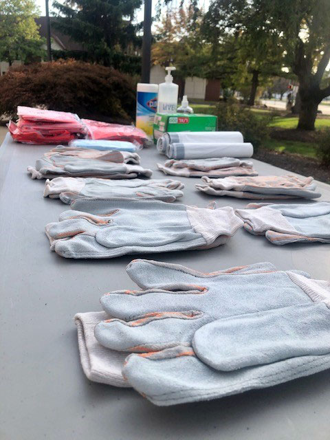 Gloves and trash bags line the table at the starting point for “(community) Service Saturday,” centered this past week on campus cleanup.