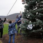Nearing the end of the line, Beaver (left), Jones and Caputo fill in the gaps with one final strand.
