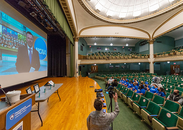 Wildcat softball players and coaches, joined in the front rows of the ACC Auditorium by their beloved mascot, await the announcement by sportcaster Will Haskett ...