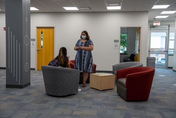 Siertle attentively listens to a student visitor.