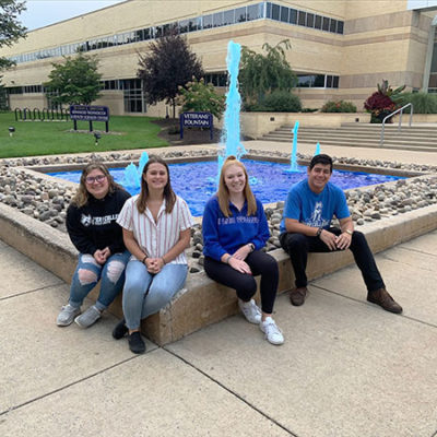 From left, WEB's Lauryn A. Stauffer, of Bath, enrolled in automation engineering technology: robotics and automation; Serena V. Bergeron, of Lansdale, automotive technology management: collision repair concentration; and Caila N. Flanagan, Williamsport, business administration: management concentration; join Luna, a health science major from San Clemente, Calif., taking a seat after a job well-done.