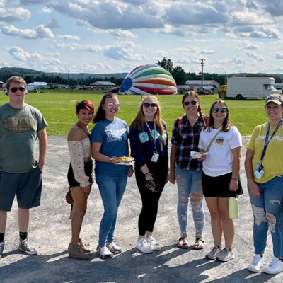Joining Skaluba (behind the camera) in helpfully representing Penn College during Saturday's event are (from left) Aaron Larson, of Erie, a forest technology student; Alicia Martinez, Allentown, aviation maintenance technology; Sophia G. Wiest, Butler, entrepreneurial innovation; Caila N. Flanagan, Danville, business administration: management concentration; Amanda F. Ritter, Williamsport, building science and sustainable design: architectural concentration; and Serena V. Bergeron, of Lansdale, and Morgan S. Wood, of Greenville, both enrolled in automotive technology management: collision repair concentration.