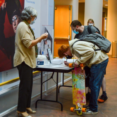 Eager to absorb an expert's insight (and get class credit for attending), students check in.
