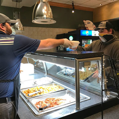 Residence Life staff – including Kyle W. Kern (left), housing coordinator for Campus View and The Village apartments – joined Dining Services in making sure students were satisfactorily fed.