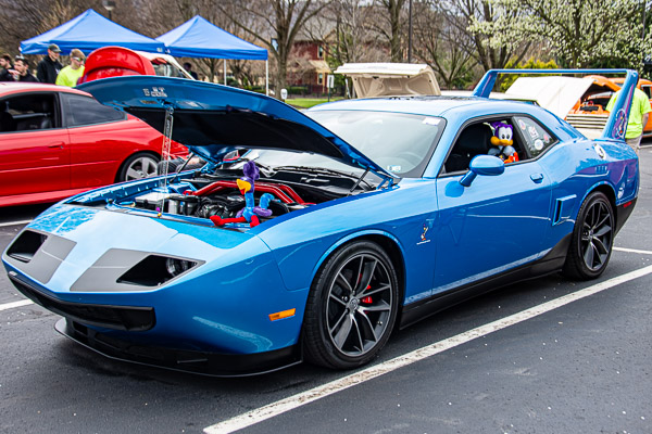 A Plymouth Road Runner Superbird pops its hood and lowers a window to accommodate its cartoon inspiration.