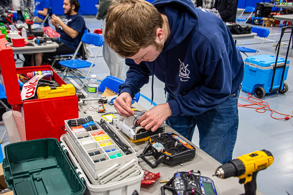 Working on his robot, Awfset, is engineering design technology student Benson Paul Weaver, of Lancaster.