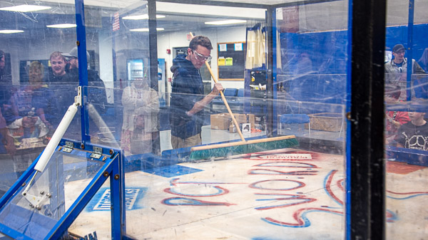 Stephen C. Brodecki, of Cochranville, pursuing a bachelor's degree in engineering design technology, sweeps up after a match.