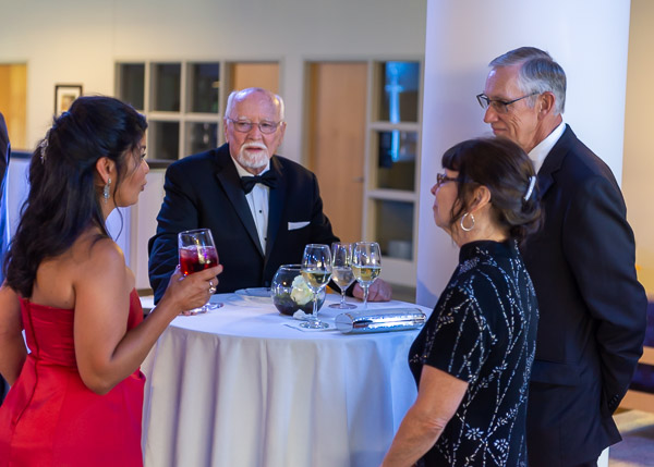 Larry A. Ward (center), whose philanthropy equipped the explosive metamorphosis of the college's machining labs, talks with  Ana Gonzalez-White (left), director of development at the Community Arts Center, and John M. and Linda D. Confer.