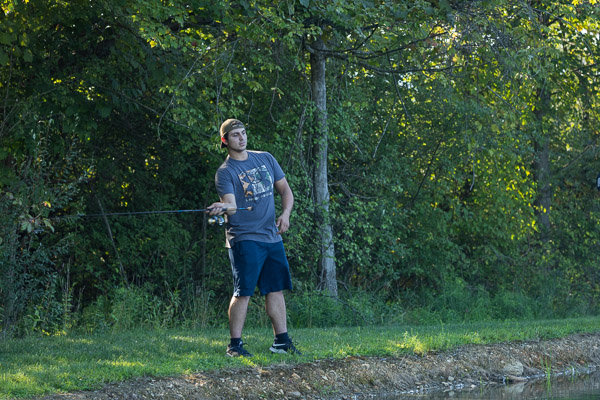 ... while Jake M. Spinosa attempts a perfect cast from the bank. The Wood Ridge, N.J., resident is enrolled in heavy construction equipment technology: technician emphasis.
