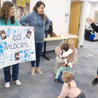 Christie A. Bing Kracker, director of the LEAP Center, savors a warm Bunny hug during the children's visit to the Davie Jane Gilmour Center. Standing (from left) are Melissa M. Stocum, LEAP adviser- mentoring; Allison M. Savage, LEAP adviser-communications; and (partially visible) Stacie L. Smith, CLC group leader.