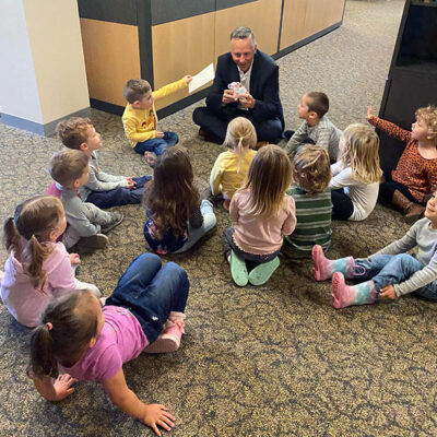 President Michael J. Reed gets on the level with a class of Bears – bear-ing gifts, no less – who visited the executive offices.