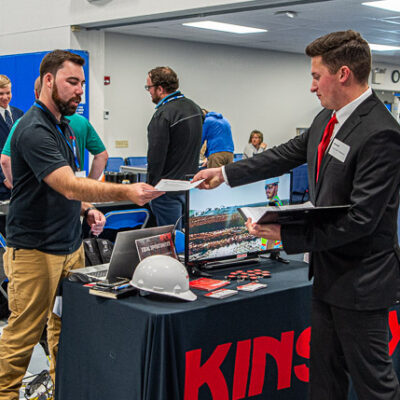 Mitchell G. McAfee, enrolled in construction management, hands his resume to Kyle Lukoskie, of CB Construction Services.