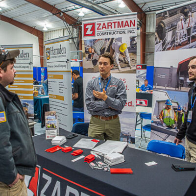 Zartman Construction Inc.'s Dan Zartman (center) and William J. Marzeski Jr. (right), a 2021 construction management grad, discuss careers with Tyler C. Martin, of Selinsgrove, a welding & fabrication engineering technology student.